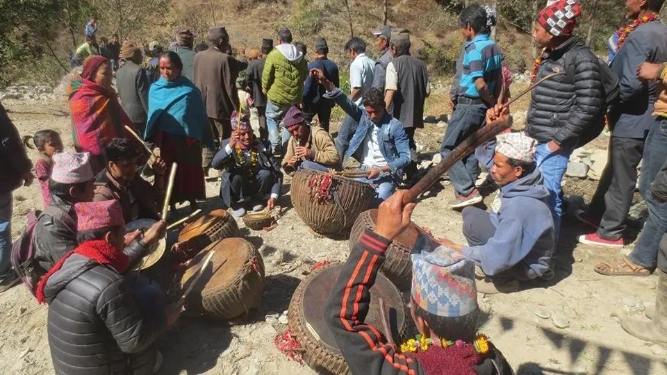 Damai musicians playing traditional panche baja instruments including damaha narsingha sanai at Nepali wedding ceremony